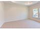 Bright bedroom with neutral carpeting and large window at 76 Brooklynn Trl, Angier, NC 27501