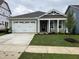 Newly constructed home with a two-car garage and well-manicured lawn at 76 Brooklynn Trl, Angier, NC 27501