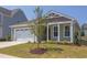 Charming house with a two-car garage, landscaping, and a tree in the front yard at 76 Brooklynn Trl, Angier, NC 27501