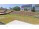Two-story home with backyard and grassy hill at 76 Brooklynn Trl, Angier, NC 27501