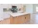 Modern kitchen with white cabinets, quartz countertops, and a gold faucet at 76 Brooklynn Trl, Angier, NC 27501