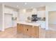 Spacious kitchen with an island, stainless steel appliances, and light wood cabinets at 76 Brooklynn Trl, Angier, NC 27501