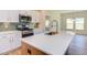 Modern kitchen with white cabinets, a gas range, and a large island at 76 Brooklynn Trl, Angier, NC 27501