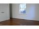 Bedroom with hardwood floors, window, and door at 805 Richmond St, Raleigh, NC 27609