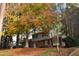 Two-story brick house nestled among fall trees at 805 Richmond St, Raleigh, NC 27609