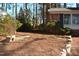 Side yard with pine straw and stone border at 805 Richmond St, Raleigh, NC 27609