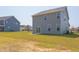 House exterior showcasing a two-story home and grassy backyard at 86 Barn Door Dr, Lillington, NC 27546