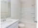 Clean bathroom with white vanity, shower/tub combo, and tile floor at 86 Barn Door Dr, Lillington, NC 27546