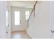 Bright entryway with hardwood floors, white door, and staircase at 86 Barn Door Dr, Lillington, NC 27546