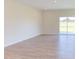 Spacious Gathering room with hardwood floors and sliding glass doors at 86 Barn Door Dr, Lillington, NC 27546