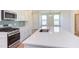 Modern kitchen with white cabinets, quartz countertops, and stainless steel appliances at 86 Barn Door Dr, Lillington, NC 27546