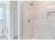 Elegant shower with marble-style tile and glass enclosure at 86 Barn Door Dr, Lillington, NC 27546