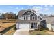 Two-story house with gray siding, white garage door, and landscaping at 86 Brooklynn Trl, Angier, NC 27501