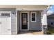 Modern black front door with sidelight and gray siding at 86 Brooklynn Trl, Angier, NC 27501
