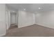 Carpeted hallway with doors to bedrooms and bathrooms at 86 Brooklynn Trl, Angier, NC 27501
