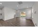 Bright living room with hardwood floors and sliding glass door to backyard at 86 Brooklynn Trl, Angier, NC 27501