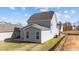 Two story house with gray siding, sliding glass doors, and a patio at 86 Brooklynn Trl, Angier, NC 27501