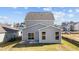 Two story house with gray siding, sliding glass doors, and a patio at 86 Brooklynn Trl, Angier, NC 27501