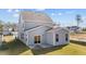 Two story house with gray siding, sliding glass doors, and a patio at 86 Brooklynn Trl, Angier, NC 27501