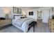 Bright bedroom with a padded headboard, neutral color palette, and framed artwork above the bed at 8705 Wardle Ct, Wake Forest, NC 27587