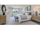 Bright primary bedroom featuring a large window with backyard view, neutral decor, and carpet flooring at 8712 Wardle Ct, Wake Forest, NC 27587