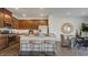 Modern kitchen featuring an island with bar seating, stainless steel appliances, and an adjacent dining area at 8712 Wardle Ct, Wake Forest, NC 27587