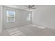 Bright bedroom with two windows, ceiling fan, and neutral carpeting at 8798 Kenridge Ln, Fuquay Varina, NC 27526