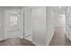 Hallway with wood-look floors and doors to bedrooms at 8798 Kenridge Ln, Fuquay Varina, NC 27526