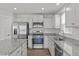 Modern kitchen with stainless steel appliances and granite countertops at 8798 Kenridge Ln, Fuquay Varina, NC 27526