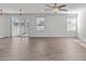 Bright living room featuring hardwood floors and sliding glass doors to patio at 8798 Kenridge Ln, Fuquay Varina, NC 27526