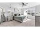 Spacious bedroom with large windows, ceiling fan, and plush bedding at 931 Haybeck Ln, Apex, NC 27523