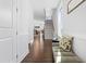 Bright entryway with hardwood floors, bench seating, and view of staircase at 931 Haybeck Ln, Apex, NC 27523