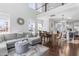 Open living space with hardwood floors, sectional sofa, and a view into the kitchen and dining area at 931 Haybeck Ln, Apex, NC 27523