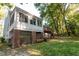Spacious backyard featuring a sunroom with large windows and a deck with stairs at 1003 Pagoda Pl, Knightdale, NC 27545