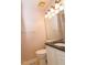 Small bathroom with granite countertop, white cabinets, and updated light fixture at 1003 Pagoda Pl, Knightdale, NC 27545