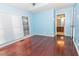 Light blue bedroom with hardwood floors and access to a bathroom at 1003 Pagoda Pl, Knightdale, NC 27545