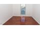 Simple bedroom with hardwood floors, neutral walls, and a window at 1003 Pagoda Pl, Knightdale, NC 27545