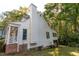 Charming white two-story house featuring a brick foundation and a tall chimney at 1003 Pagoda Pl, Knightdale, NC 27545