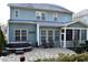 Backyard with hot tub, stone patio, seating area and screened porch at 104 Warm Wood Ln, Apex, NC 27539