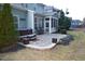 Backyard with a stone patio, seating, and hot tub, perfect for outdoor entertaining at 104 Warm Wood Ln, Apex, NC 27539