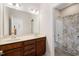 Dual sink bathroom with a shower featuring neutral finishes and modern lighting at 104 Warm Wood Ln, Apex, NC 27539