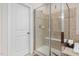 Modern bathroom featuring glass-enclosed shower with built-in bench and tiled walls at 104 Warm Wood Ln, Apex, NC 27539