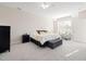 Bright bedroom shows bed, cushioned storage bench, dresser, chairs with plush carpeting and lots of natural light at 104 Warm Wood Ln, Apex, NC 27539