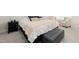A well-lit bedroom shows a comfortable bed flanked by a nightstand and chair with a cushioned storage bench at its foot at 104 Warm Wood Ln, Apex, NC 27539