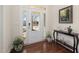 Welcoming foyer with hardwood floors and a view of the front yard through glass-paneled entry at 104 Warm Wood Ln, Apex, NC 27539