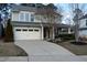 Charming two-story home with a two-car garage and landscaped front yard with tasteful plantings at 104 Warm Wood Ln, Apex, NC 27539