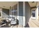 Charming front porch with stylish seating area and classic architectural details at 104 Warm Wood Ln, Apex, NC 27539