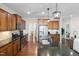 Open kitchen with stainless steel appliances, granite countertops and hardwood floors at 104 Warm Wood Ln, Apex, NC 27539