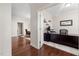 Bright home office with hardwood floors and a view into adjacent dining room space at 104 Warm Wood Ln, Apex, NC 27539