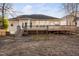 Backyard with wooden deck, stairs, lawn area, and mature trees at 107 Myers Farm Ct, Cary, NC 27519